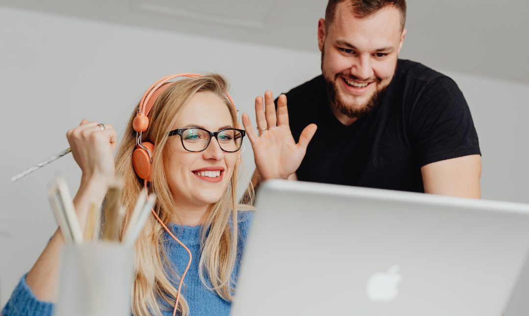 A couple on a video call with a financial advisor on their laptop